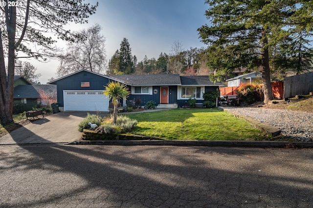 ranch-style house with a garage and a front lawn