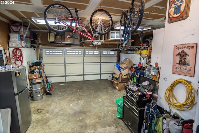 garage with stainless steel refrigerator