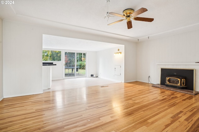 unfurnished living room with a textured ceiling, light hardwood / wood-style floors, and ceiling fan