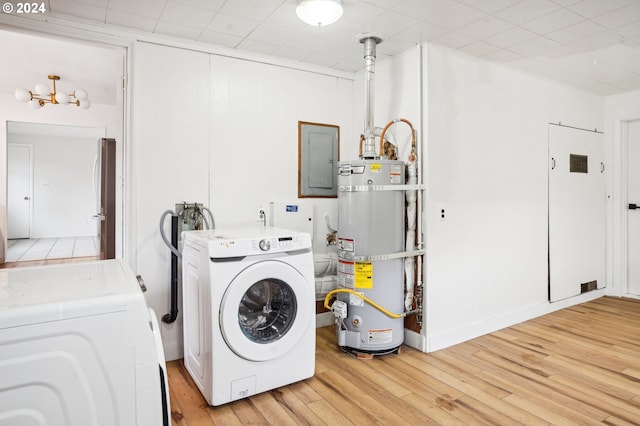 laundry area with electric panel, strapped water heater, light hardwood / wood-style floors, and independent washer and dryer