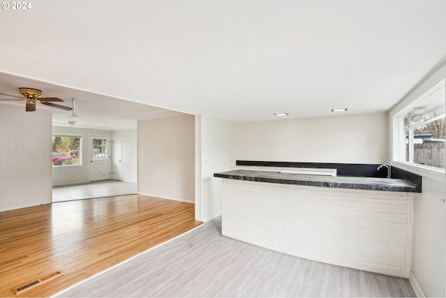 kitchen with wood-type flooring and ceiling fan