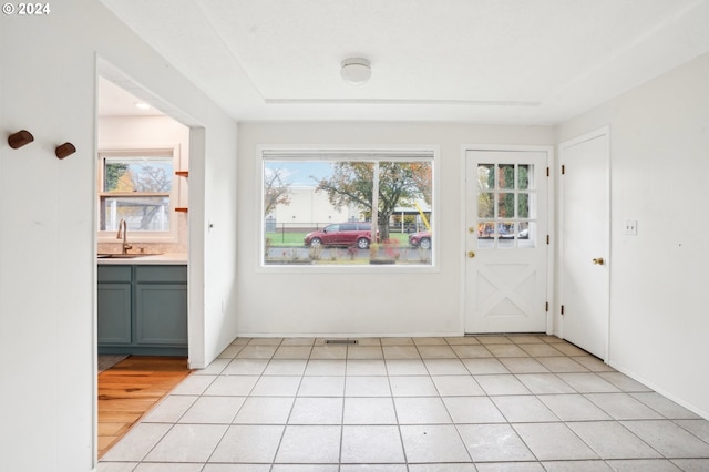 interior space with sink and light tile patterned floors