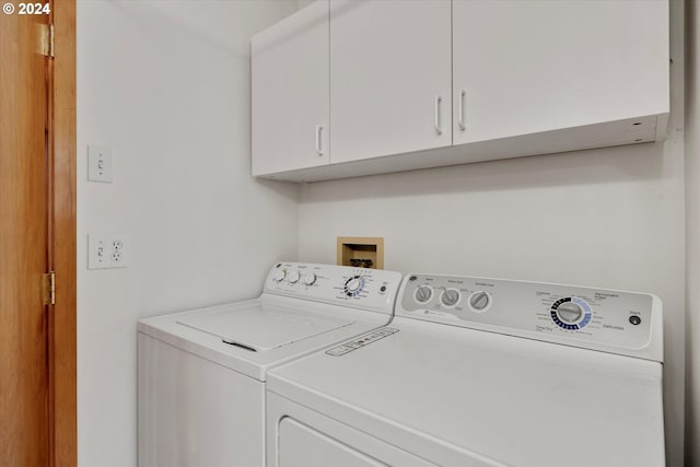laundry area with washer and dryer and cabinet space