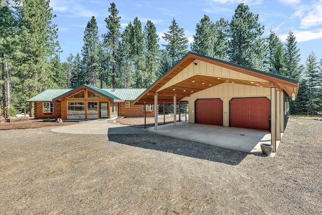 view of front of property featuring a garage, a carport, and driveway