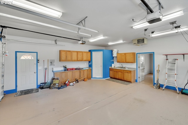 garage with a sink and a garage door opener