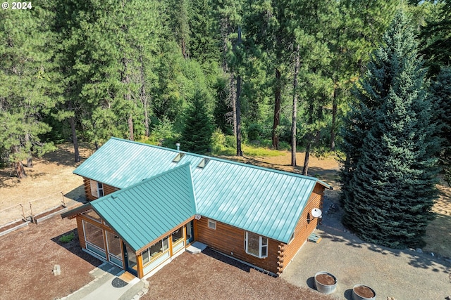 birds eye view of property featuring a view of trees