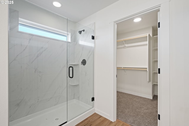 11122 NE 91st Ave, Vancouver, WA 98662 - full bathroom featuring a marble finish shower, baseboards, wood finished floors, and a walk in closet