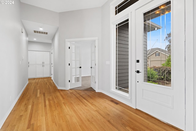 entrance foyer featuring plenty of natural light and light hardwood / wood-style floors