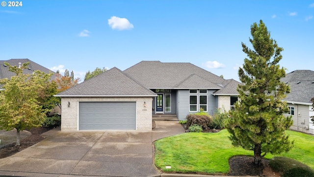 view of front of house featuring a garage and a front lawn