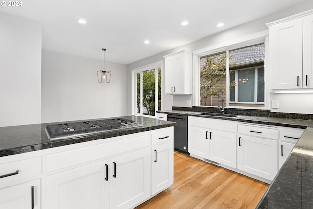 kitchen with dishwasher, sink, light wood-type flooring, white cabinetry, and stainless steel gas cooktop