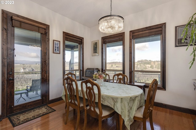 dining area featuring a chandelier and dark wood-type flooring