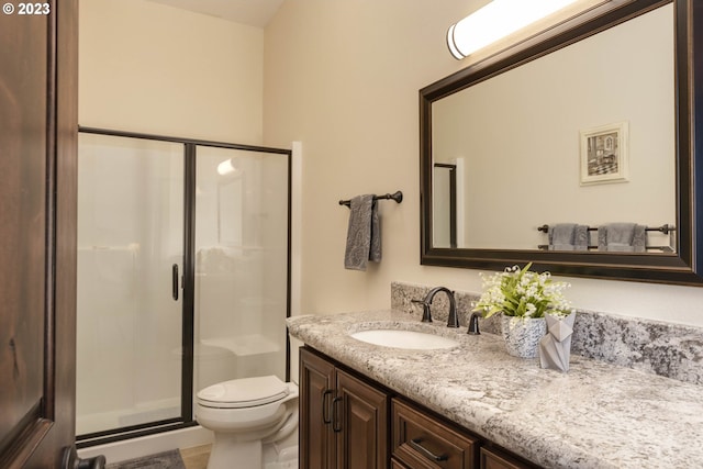 bathroom with toilet, an enclosed shower, and vanity