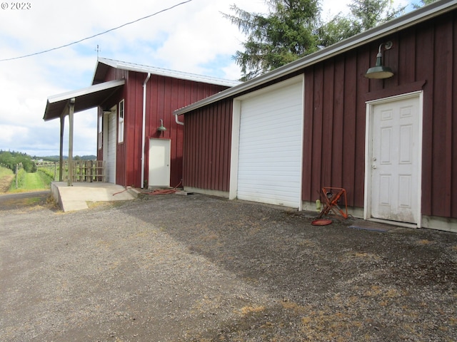 view of home's exterior with an outdoor structure and a garage