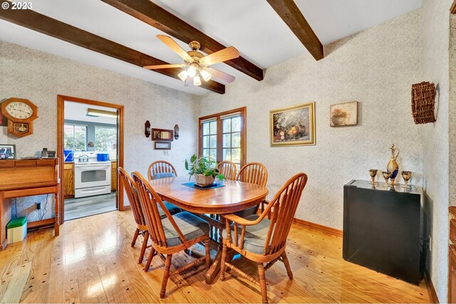 dining area with beam ceiling, ceiling fan, and light hardwood / wood-style floors