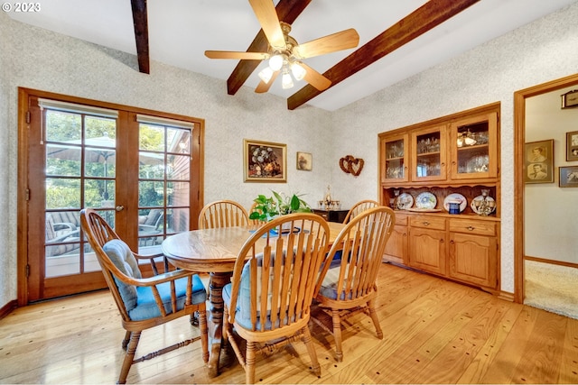 dining area featuring french doors, ceiling fan, light hardwood / wood-style floors, and beamed ceiling