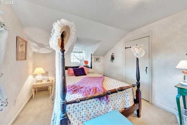 carpeted bedroom featuring lofted ceiling and a textured ceiling