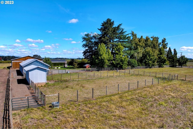 view of yard featuring a rural view and an outdoor structure