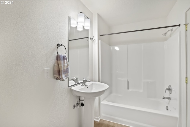 bathroom with shower / bathing tub combination and hardwood / wood-style flooring