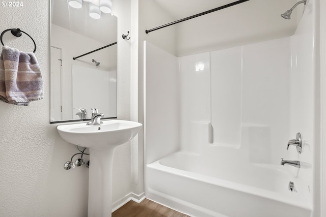 bathroom with shower / tub combination and hardwood / wood-style floors