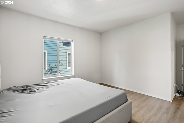 bedroom with light wood-type flooring