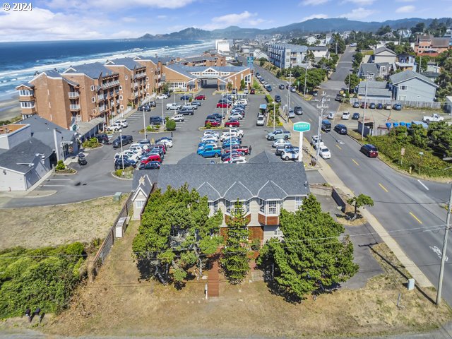 birds eye view of property with a water and mountain view