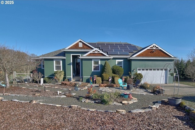 view of front facade featuring a garage and solar panels