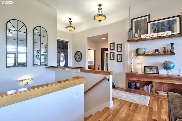 interior space featuring light hardwood / wood-style floors and hanging light fixtures