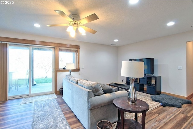 living room featuring hardwood / wood-style flooring and ceiling fan