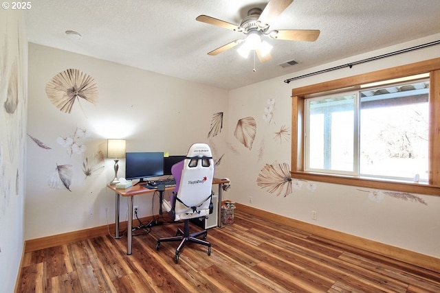 office area featuring ceiling fan, a textured ceiling, and dark hardwood / wood-style flooring