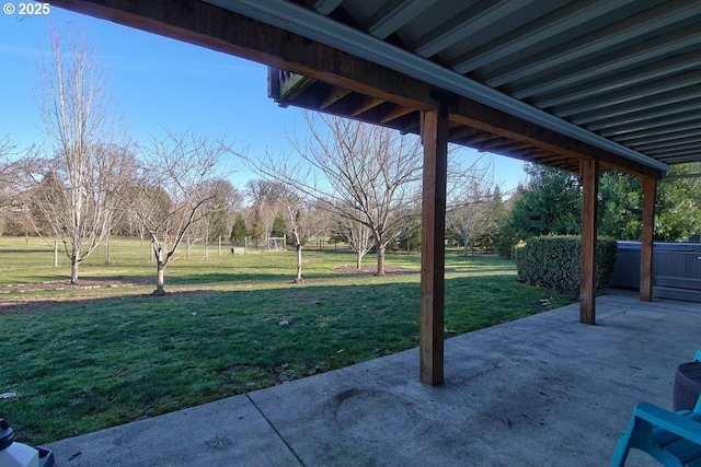 view of yard featuring a patio area and a hot tub