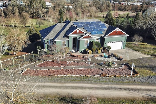 view of front facade featuring a garage and solar panels