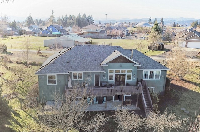 rear view of property featuring a patio area, a deck, and french doors