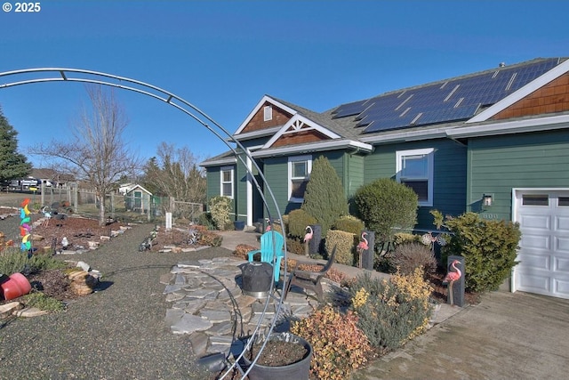 view of front of property featuring solar panels