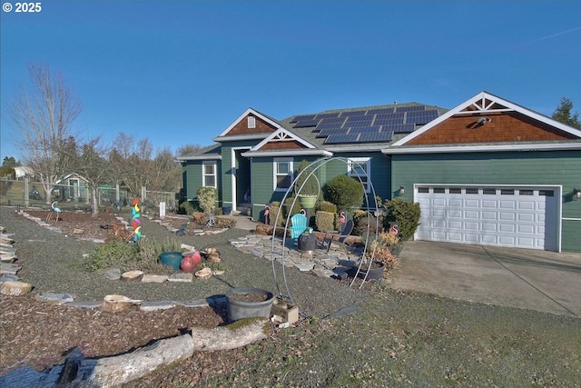 view of front of house with a garage and solar panels