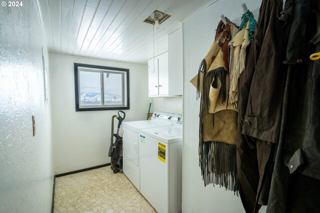 washroom with cabinets, independent washer and dryer, and wood ceiling