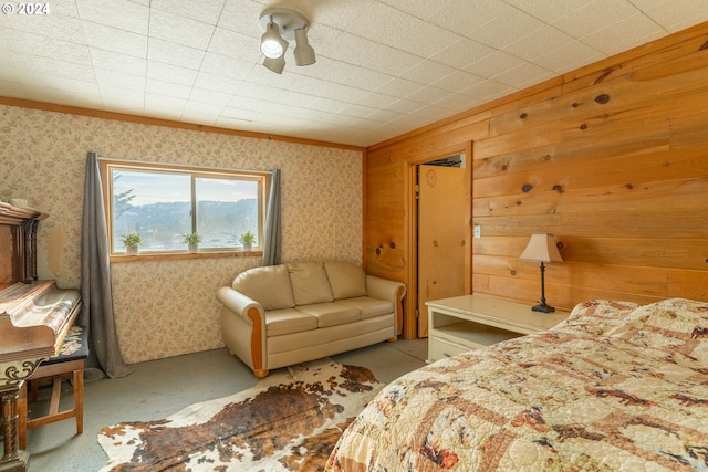 bedroom featuring wood walls