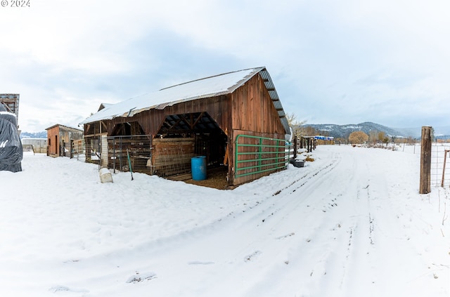 snow covered structure with a mountain view