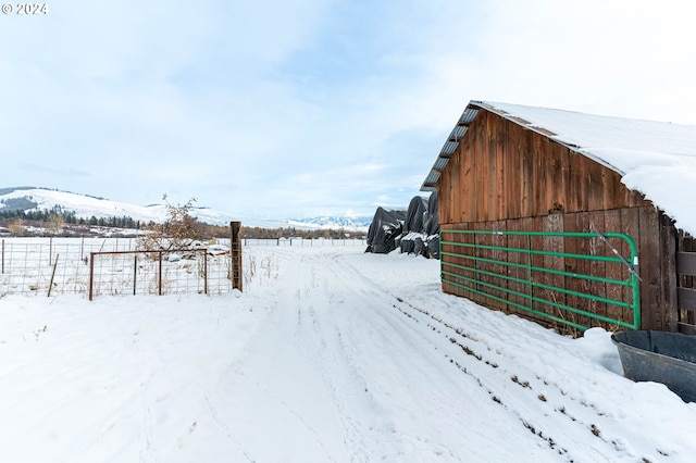 snow covered structure with a mountain view