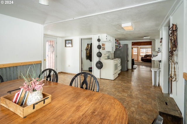 dining area featuring a textured ceiling