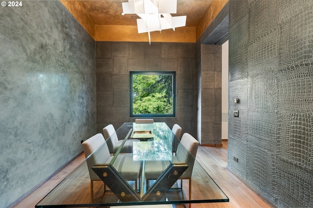 dining room with wood-type flooring and a skylight