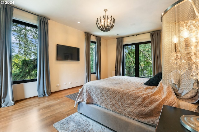 bedroom featuring a chandelier and light hardwood / wood-style floors