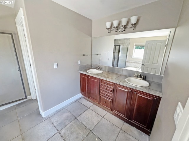 bathroom with vanity, tile patterned flooring, and a shower with shower door