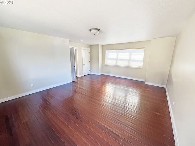 spare room with dark hardwood / wood-style flooring