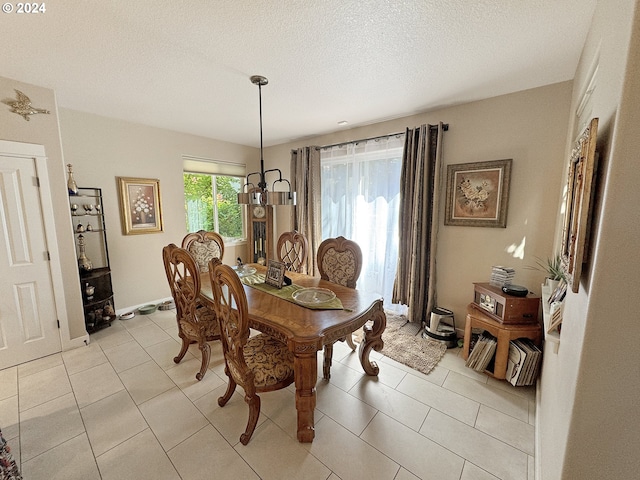 tiled dining area featuring a textured ceiling