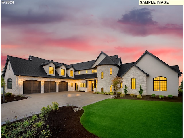 french country home with a garage and a yard