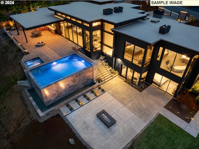 exterior space featuring a fire pit and a patio area