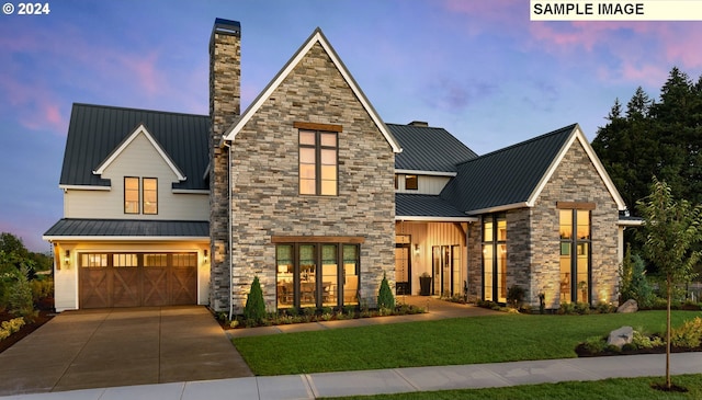 view of front of home featuring a lawn and a garage