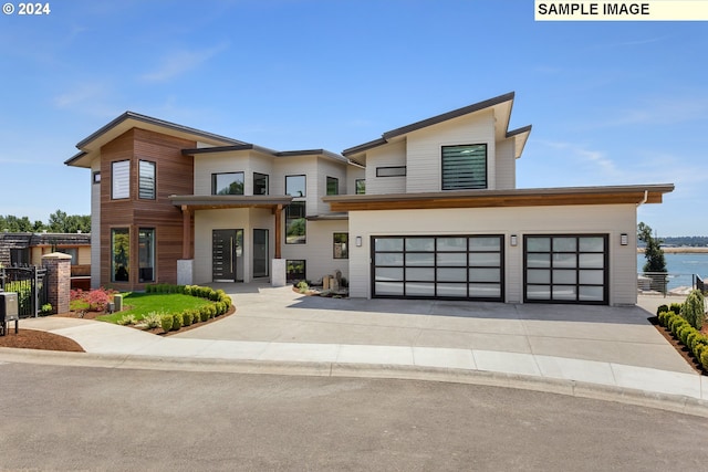 contemporary house with a garage and a water view