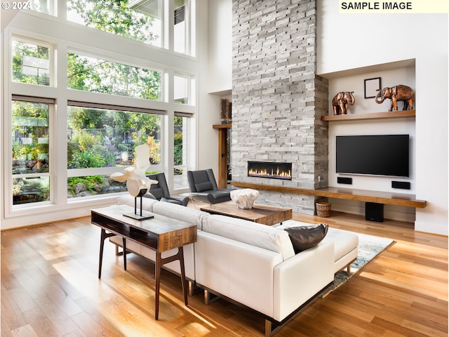 living room featuring a towering ceiling and a healthy amount of sunlight