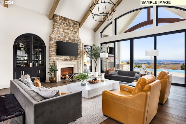 living room featuring a fireplace, a notable chandelier, beam ceiling, high vaulted ceiling, and hardwood / wood-style floors